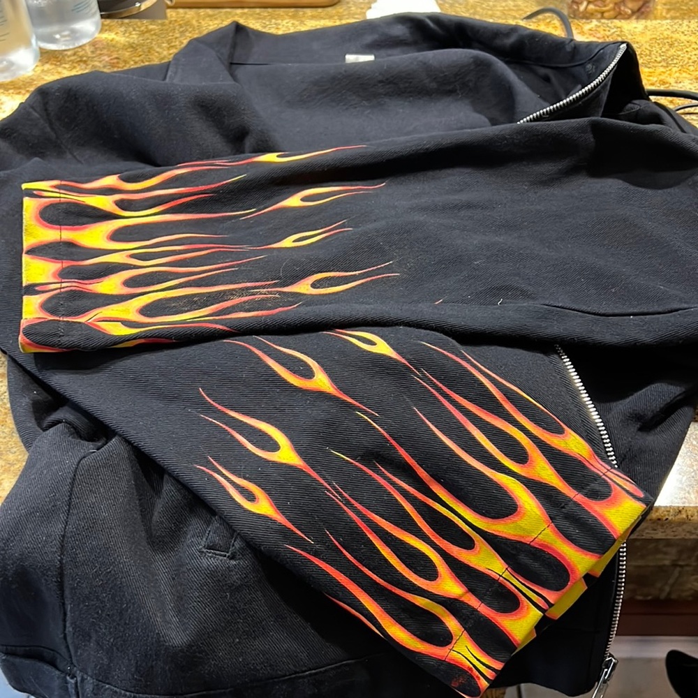 2X lucky 13 jacket with flamed sleeves has pockets and the front zipper